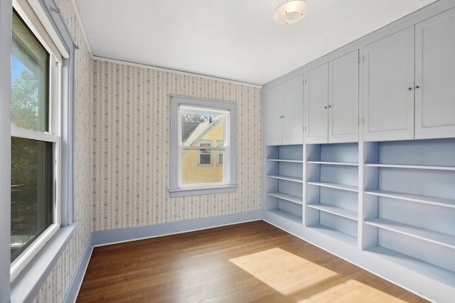 spare room with crown molding and hardwood / wood-style floors