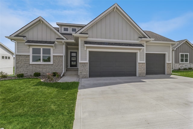 craftsman house with a front yard and a garage