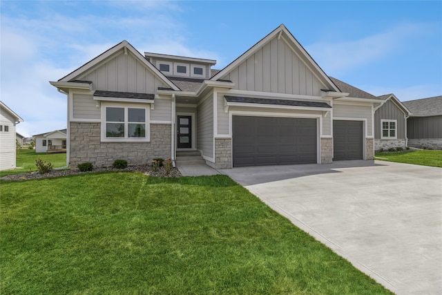 craftsman house with a garage and a front lawn