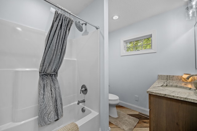 full bathroom featuring vanity, hardwood / wood-style flooring, toilet, and shower / bathtub combination with curtain