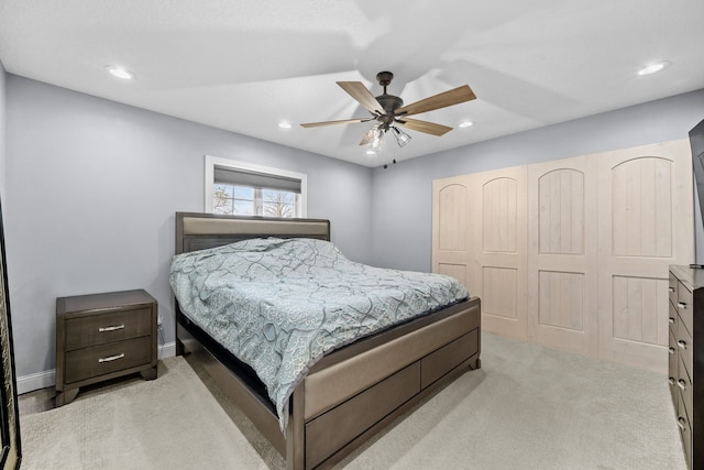 bedroom featuring a closet, ceiling fan, and light colored carpet