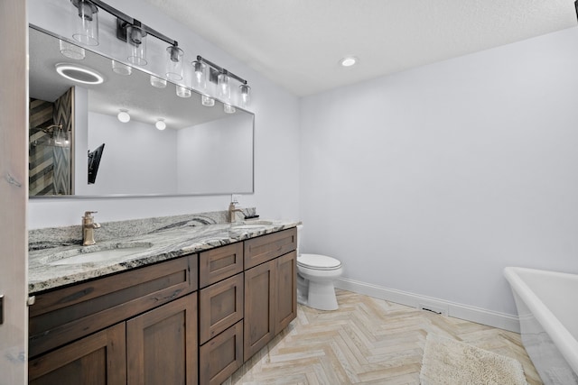 bathroom featuring vanity, parquet floors, a tub to relax in, and toilet