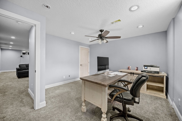 home office with light carpet, a textured ceiling, and ceiling fan