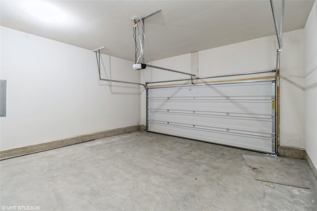 garage with a garage door opener and electric panel