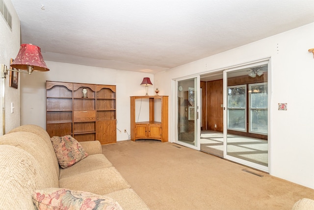 unfurnished living room with a textured ceiling and carpet flooring