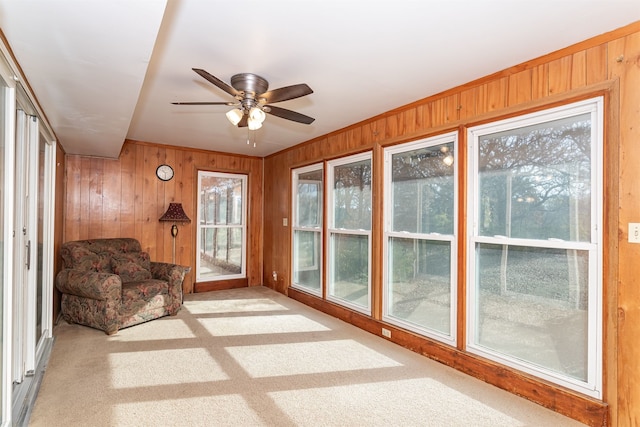 sunroom with ceiling fan and lofted ceiling