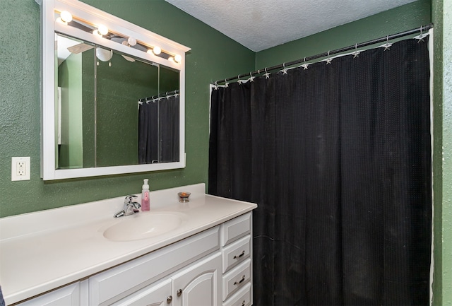 bathroom with vanity and a textured ceiling