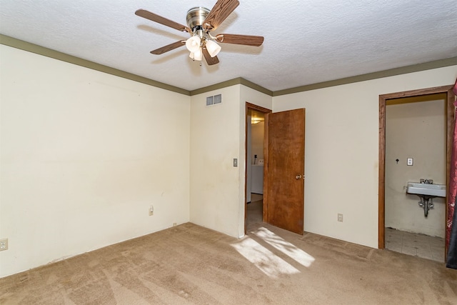 unfurnished bedroom featuring ceiling fan, light carpet, and sink