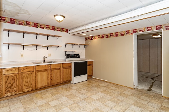 kitchen with white electric stove and sink