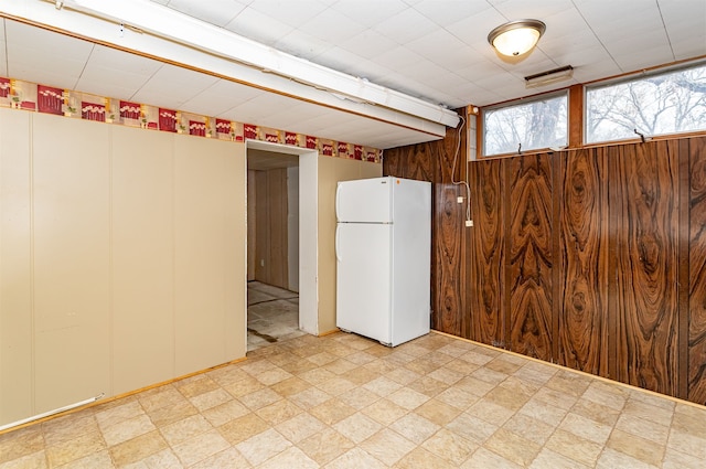 interior space with wood walls and white refrigerator