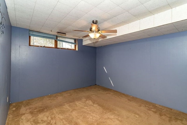 basement featuring ceiling fan and carpet flooring