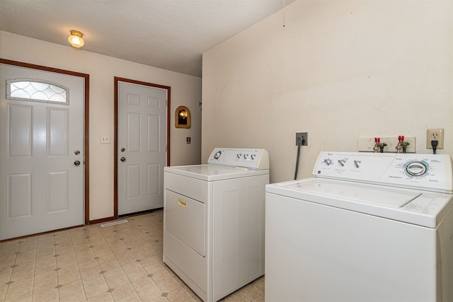 washroom featuring independent washer and dryer and a textured ceiling