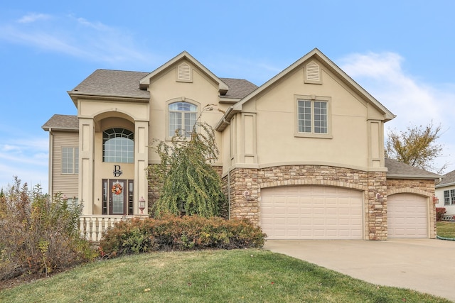 view of front of property featuring a front yard and a garage