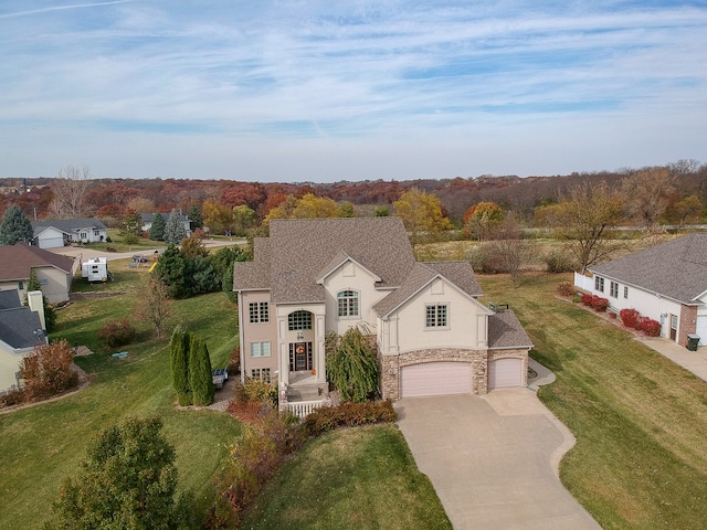 view of front of house with a front yard and a garage