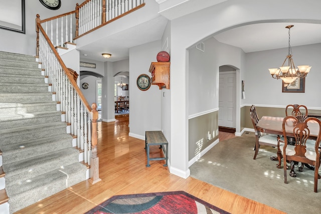 foyer entrance featuring hardwood / wood-style flooring and an inviting chandelier