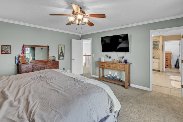 bedroom with crown molding, ensuite bathroom, light colored carpet, and ceiling fan