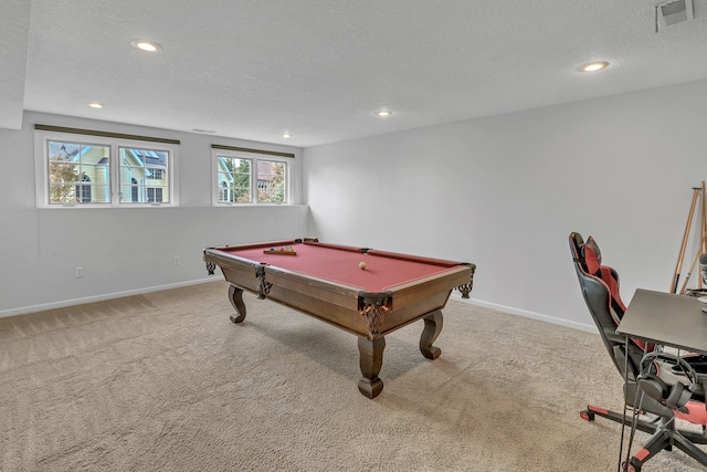 rec room with a textured ceiling, billiards, and light colored carpet