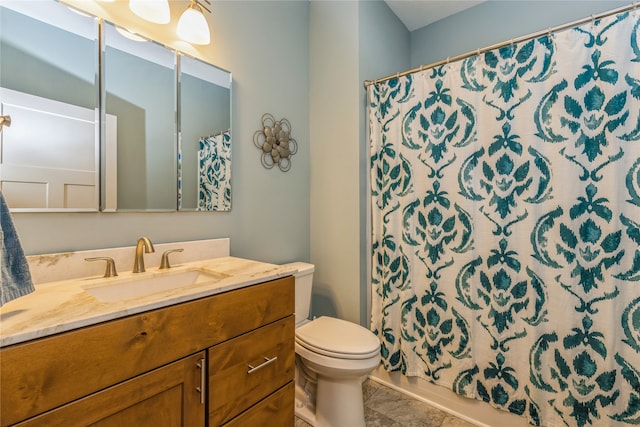 bathroom with vanity, toilet, and tile patterned floors