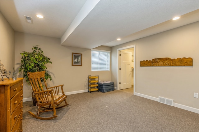 sitting room featuring carpet flooring