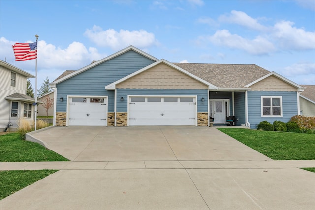 view of front of house featuring a front lawn and a garage