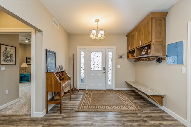 entrance foyer with dark hardwood / wood-style flooring and an inviting chandelier