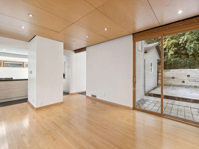 interior space with recessed lighting, visible vents, baseboards, and wood finished floors