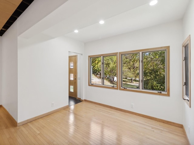 empty room with recessed lighting, wood-type flooring, and baseboards