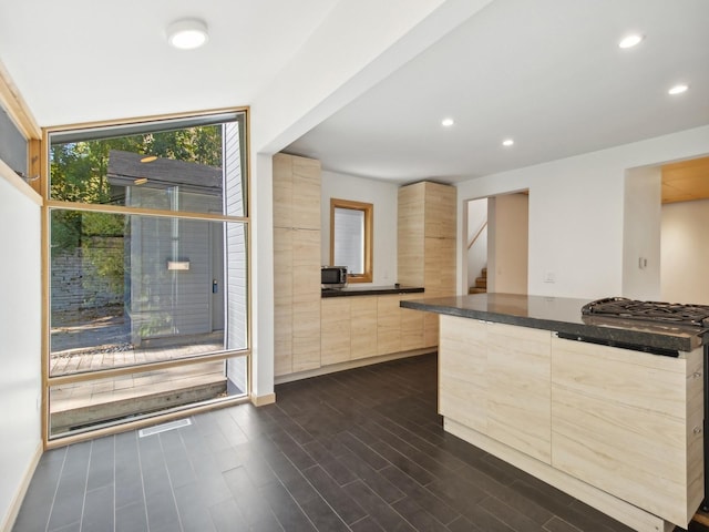 kitchen featuring dark wood-style flooring, modern cabinets, light brown cabinets, and recessed lighting