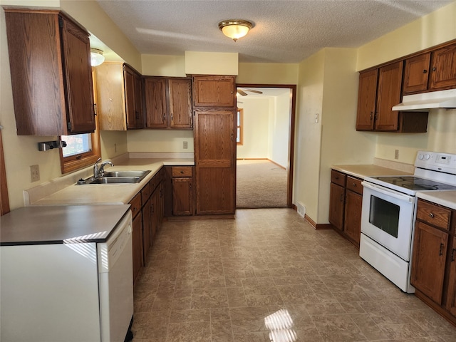 kitchen with a textured ceiling, sink, and electric stove