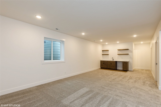 interior space featuring sink and light colored carpet