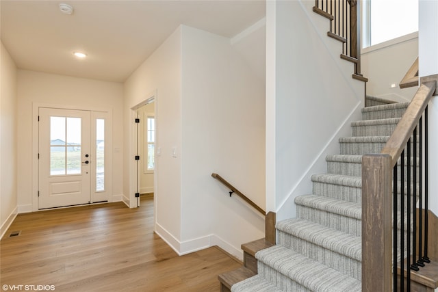 entrance foyer featuring light wood finished floors, visible vents, and baseboards