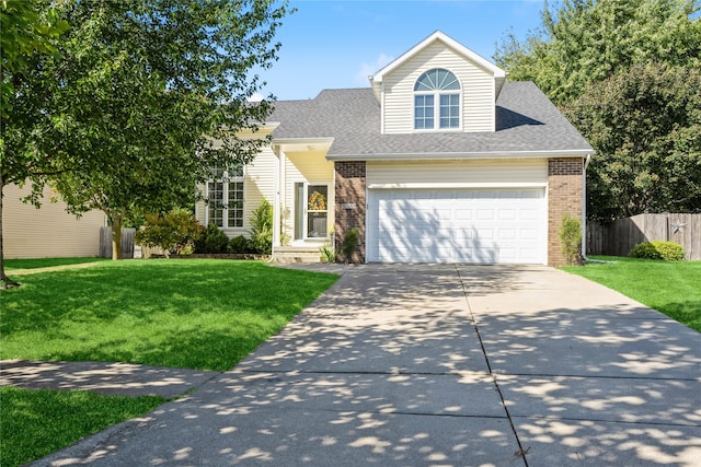 view of front of home with a front yard and a garage