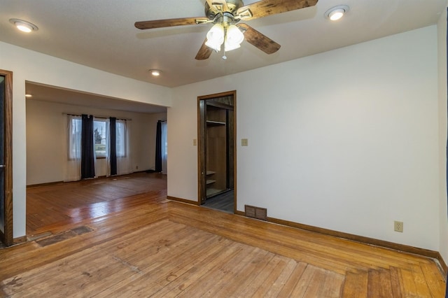 empty room featuring ceiling fan and wood-type flooring