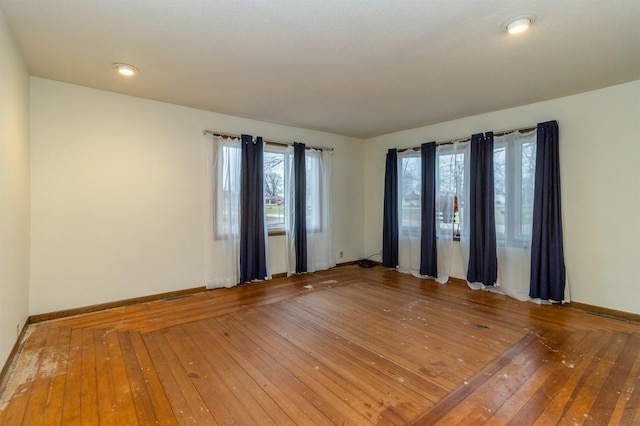 unfurnished room with hardwood / wood-style flooring