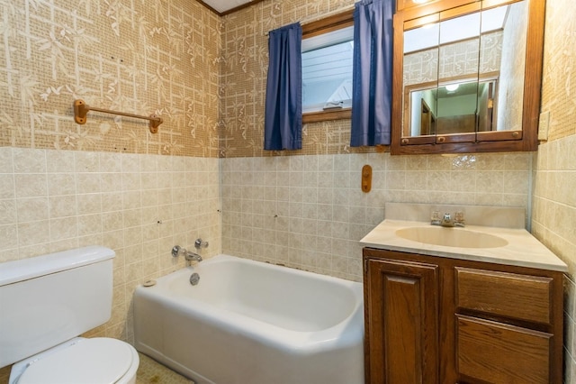 bathroom featuring vanity, a bath, tile walls, and toilet