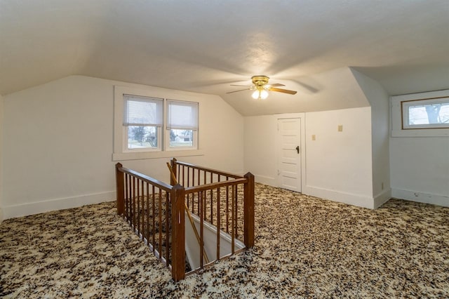 additional living space featuring carpet flooring, ceiling fan, and vaulted ceiling