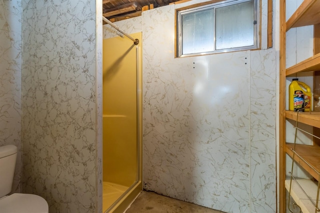 bathroom featuring concrete floors, an enclosed shower, and toilet