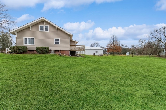 view of property exterior with a lawn and a deck