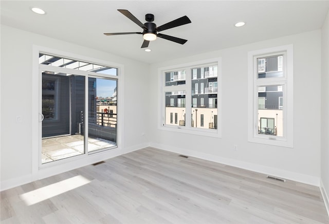 empty room featuring ceiling fan and light wood-type flooring