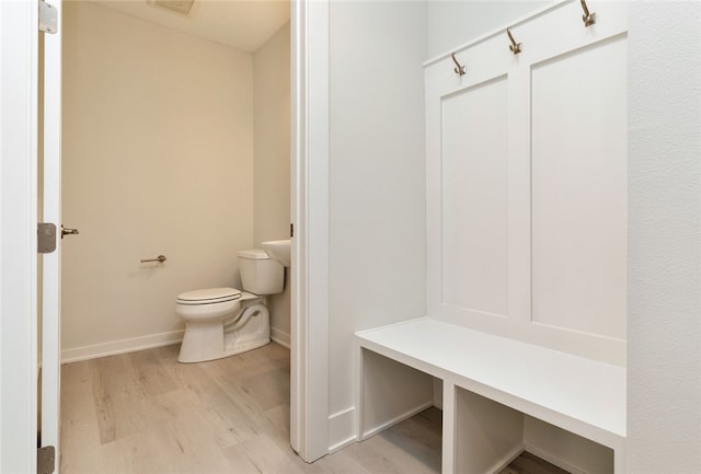 bathroom featuring wood-type flooring and toilet