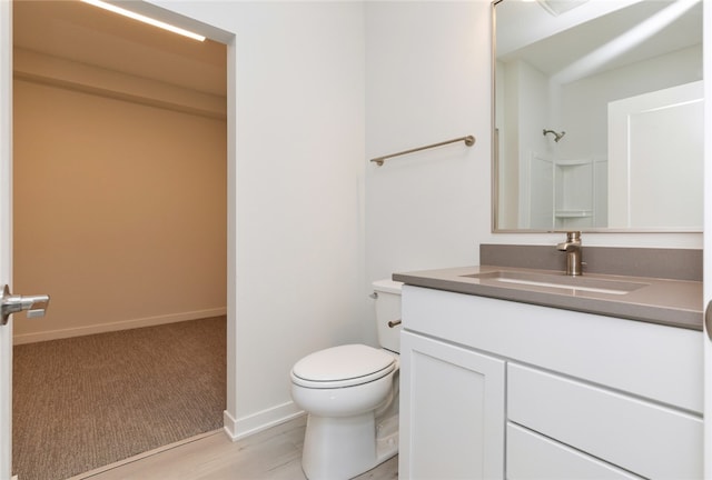 bathroom with vanity, hardwood / wood-style floors, and toilet