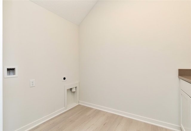 laundry area with light hardwood / wood-style floors, hookup for an electric dryer, hookup for a washing machine, and cabinets