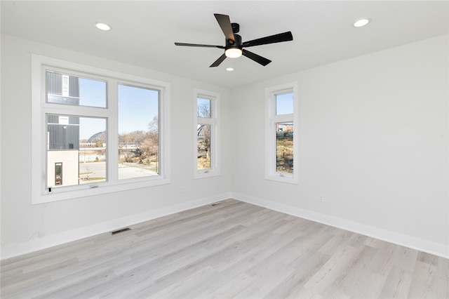 unfurnished room featuring light hardwood / wood-style flooring and ceiling fan