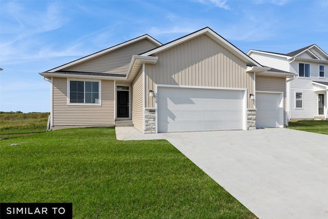 view of front of property featuring a front yard and a garage