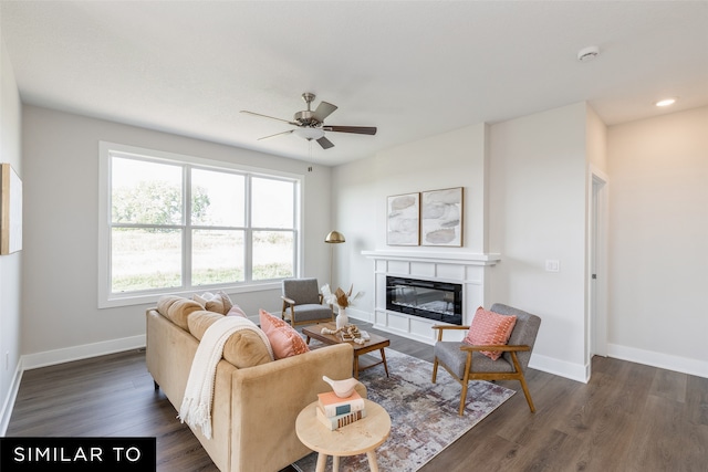 living room with ceiling fan and dark hardwood / wood-style floors