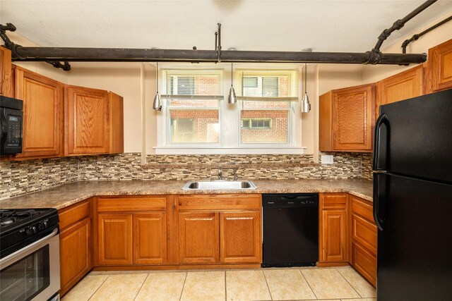 3940 University Ave Unit 1, Des Moines, IA 50311 - kitchen with black appliances, brown cabinets, and light tile patterned flooring