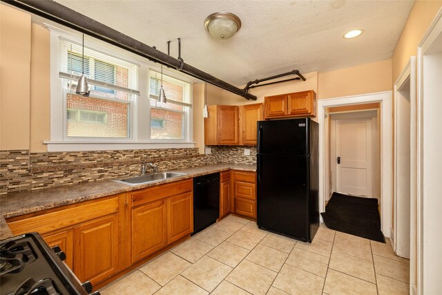 3940 University Ave Unit 1, Des Moines, IA 50311 - kitchen with black appliances, tasteful backsplash, light tile patterned floors, plenty of natural light, and a textured ceiling