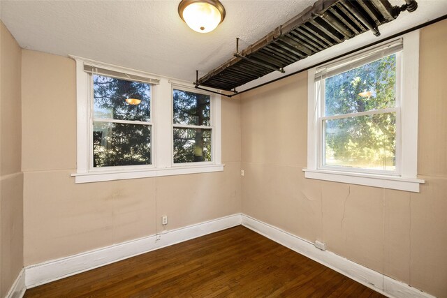 3940 University Ave Unit 1, Des Moines, IA 50311 - spare room featuring dark wood finished floors and baseboards