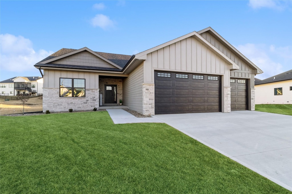 view of front of home with a garage and a front lawn