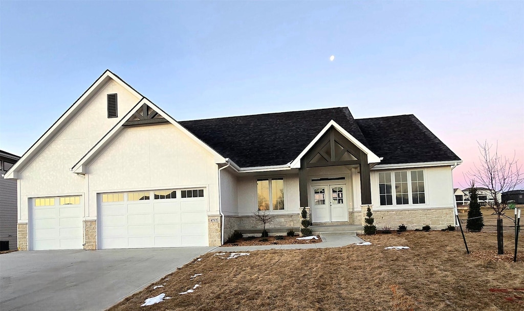 craftsman house with central air condition unit and a garage